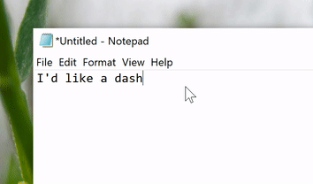 GIF of text being typed into Notepad. The text reads "I'd like a dash" followed by two hyphens that automatically convert to an em dash.